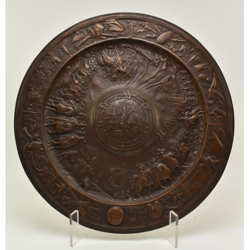 144 - A large 19th century continental wall hanging copper charger plaque. The plaque with relief central ... 