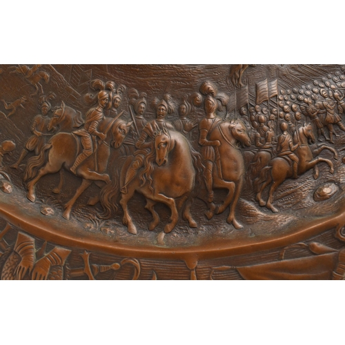 144 - A large 19th century continental wall hanging copper charger plaque. The plaque with relief central ... 