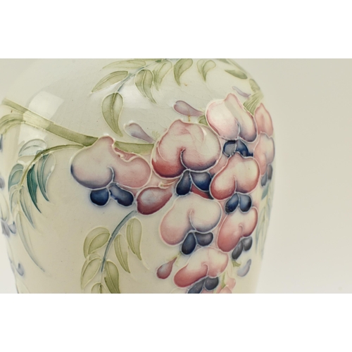 150 - William Moorcroft for Liberty & Co. - an early 20th century tube lined glazed ceramic vase in the Wi... 