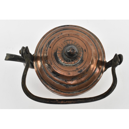 154 - A 17th century hand hammered copper kettle. The kettle featuring cast handle, the removable lid with... 