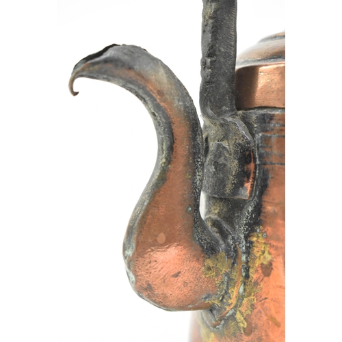 154 - A 17th century hand hammered copper kettle. The kettle featuring cast handle, the removable lid with... 