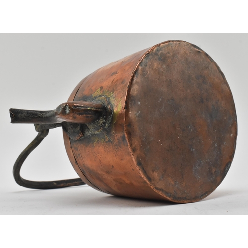 154 - A 17th century hand hammered copper kettle. The kettle featuring cast handle, the removable lid with... 