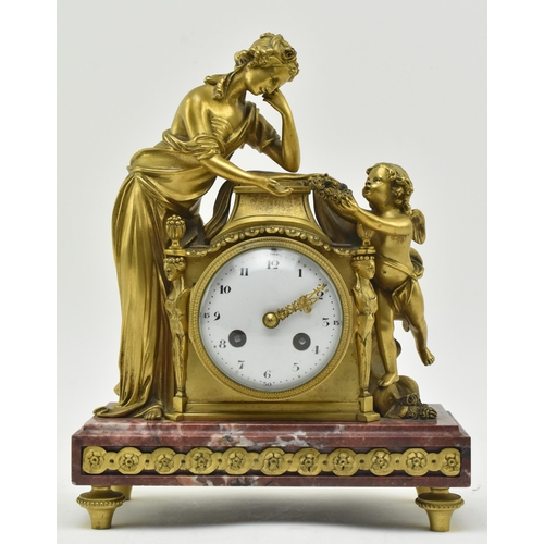 33 - A French mid 19th century gilded brass & marble 8-day mantel clock. The clock having a female al... 