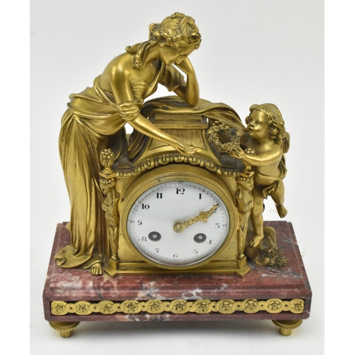 33 - A French mid 19th century gilded brass & marble 8-day mantel clock. The clock having a female al... 