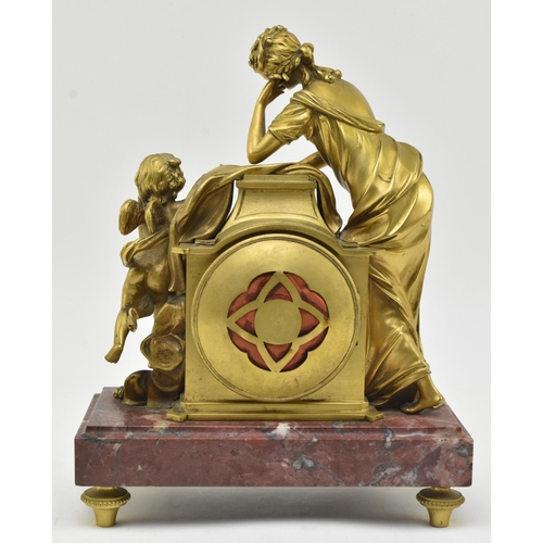 33 - A French mid 19th century gilded brass & marble 8-day mantel clock. The clock having a female al... 