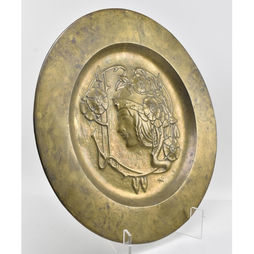 37 - Marion Henderson Wilson (1869-1956) - A Scottish Arts & Crafts embossed brass charger plate. The... 