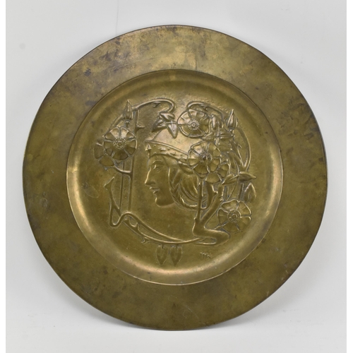 37 - Marion Henderson Wilson (1869-1956) - A Scottish Arts & Crafts embossed brass charger plate. The... 