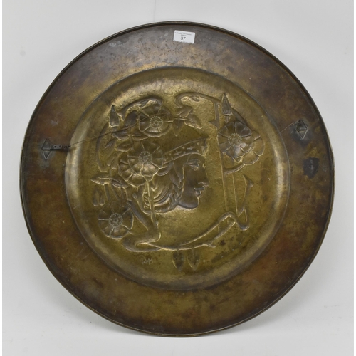 37 - Marion Henderson Wilson (1869-1956) - A Scottish Arts & Crafts embossed brass charger plate. The... 