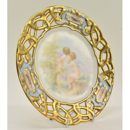 40 - Limoges - a late 19th century French porcelain cabinet plate, decorated with two hand painted cherub... 