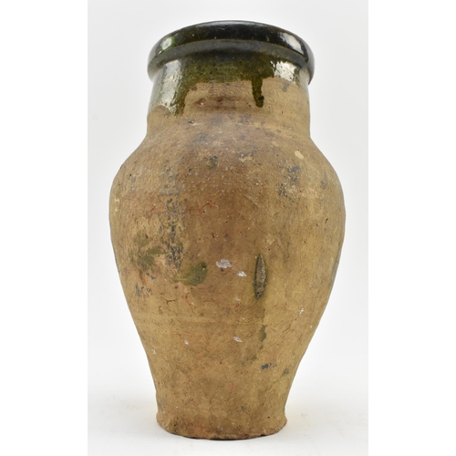 45 - A circa 14th to 16th century earthenware clay water jug / handled vase. The jug having mottled tudor... 