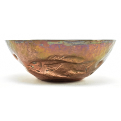 46 - Cornish Copper - an early 20th century repousse embossed copper bowl. The bowl decorated with fish, ... 