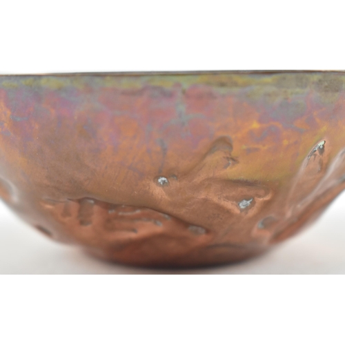 46 - Cornish Copper - an early 20th century repousse embossed copper bowl. The bowl decorated with fish, ... 