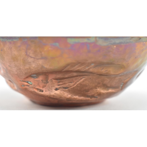 46 - Cornish Copper - an early 20th century repousse embossed copper bowl. The bowl decorated with fish, ... 