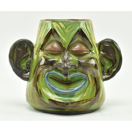 47 - C. H. Brannam Pottery - an early 20th century circa 1901 hand painted grotesque twin faced vase, pos... 