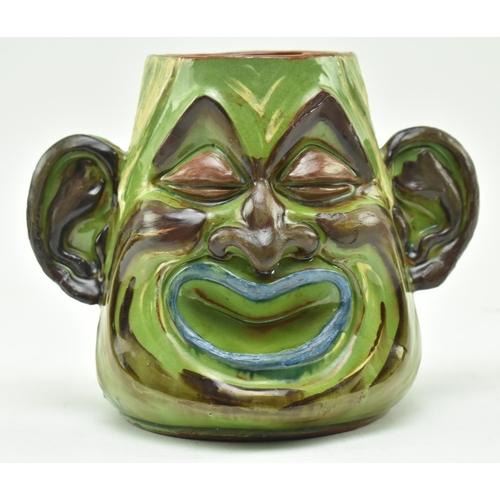 47 - C. H. Brannam Pottery - an early 20th century circa 1901 hand painted grotesque twin faced vase, pos... 