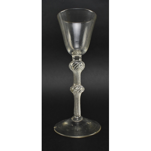 54 - A mid 18th century George II circa 1760 wine glass. The wine glass with funnel bowl over double knop... 