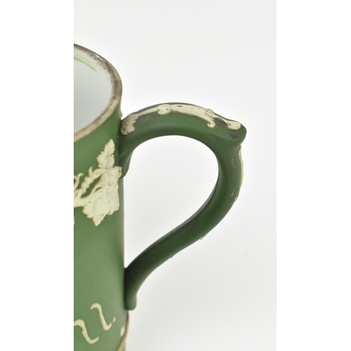 59 - Harry Barnard for Wedgwood - a pair of early 20th century c1900 jasperware mugs in olive green. Each... 