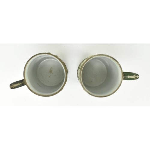 59 - Harry Barnard for Wedgwood - a pair of early 20th century c1900 jasperware mugs in olive green. Each... 