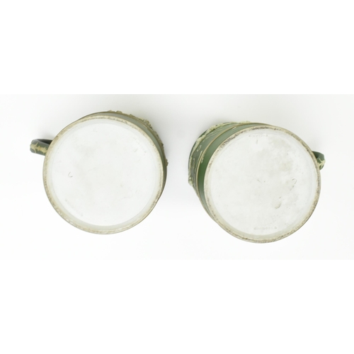 59 - Harry Barnard for Wedgwood - a pair of early 20th century c1900 jasperware mugs in olive green. Each... 