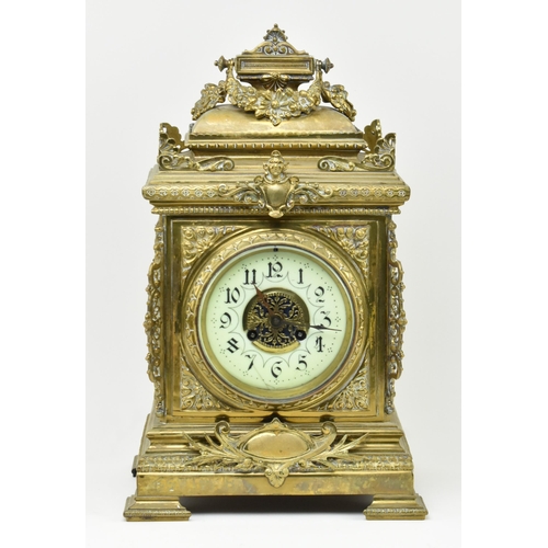 97 - An early 20th century French gilt brass 8 day mantle clock. The clock featuring gilt finial swag, pi... 