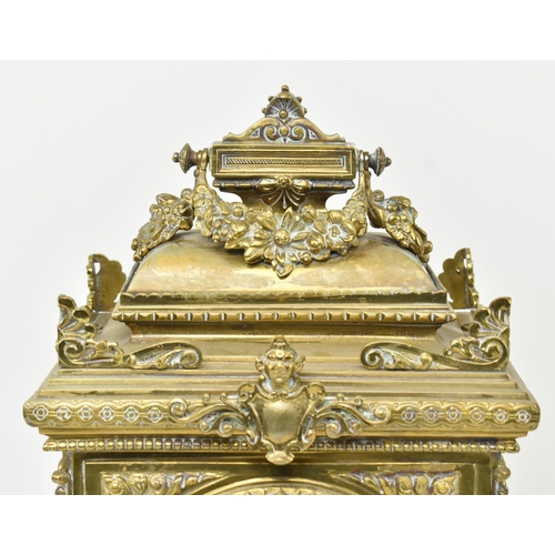 97 - An early 20th century French gilt brass 8 day mantle clock. The clock featuring gilt finial swag, pi... 