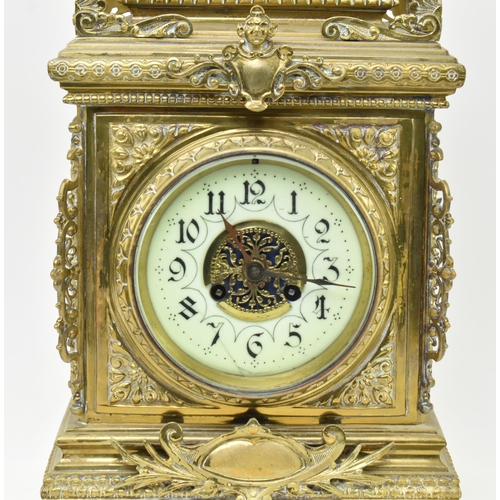 97 - An early 20th century French gilt brass 8 day mantle clock. The clock featuring gilt finial swag, pi... 