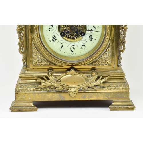 97 - An early 20th century French gilt brass 8 day mantle clock. The clock featuring gilt finial swag, pi... 