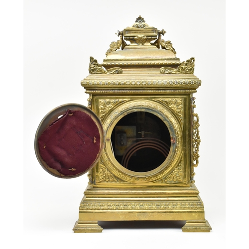 97 - An early 20th century French gilt brass 8 day mantle clock. The clock featuring gilt finial swag, pi... 