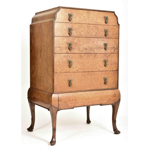 186 - A Queen Anne Revival early 20th century figured walnut veneered chest of drawers on stand. The chest... 