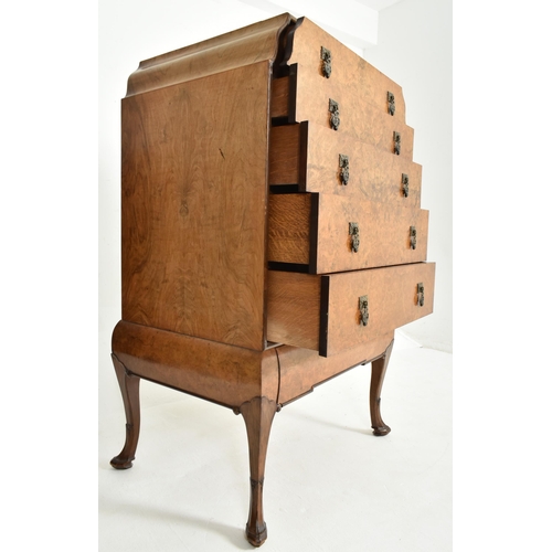 186 - A Queen Anne Revival early 20th century figured walnut veneered chest of drawers on stand. The chest... 