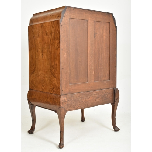 186 - A Queen Anne Revival early 20th century figured walnut veneered chest of drawers on stand. The chest... 