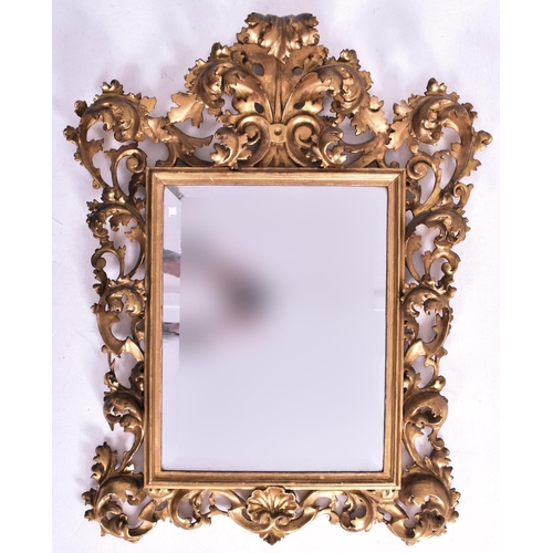 187 - An Italian Venetian 19th century giltwood wall mirror specchiera. The mirror having an intricately c... 