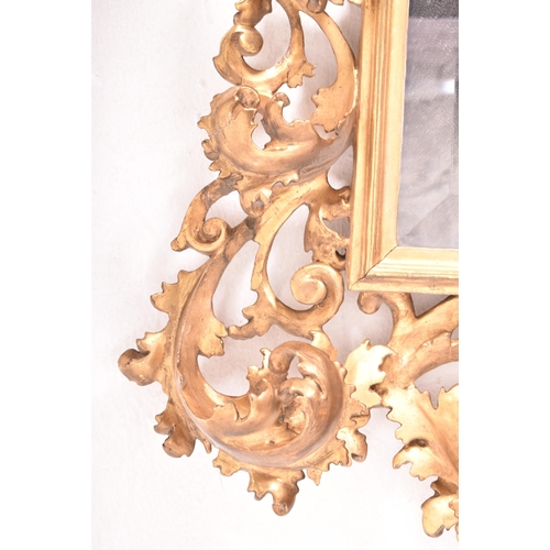 187 - An Italian Venetian 19th century giltwood wall mirror specchiera. The mirror having an intricately c... 