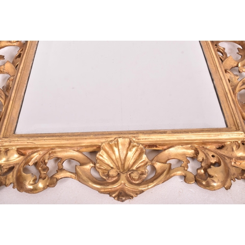 187 - An Italian Venetian 19th century giltwood wall mirror specchiera. The mirror having an intricately c... 