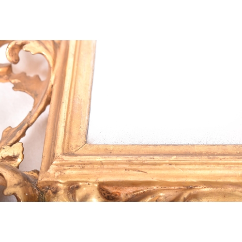 187 - An Italian Venetian 19th century giltwood wall mirror specchiera. The mirror having an intricately c... 