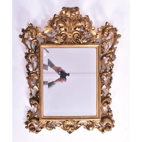 187 - An Italian Venetian 19th century giltwood wall mirror specchiera. The mirror having an intricately c... 