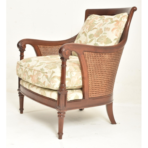 192 - A 20th century Wesley-Barrell mahogany framed and caned armchair. The chair having a curved backrest... 