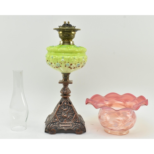 197 - An Art Nouveau 19th century two tone vaseline glass and coppered metal oil lamp. The lamp having a c... 