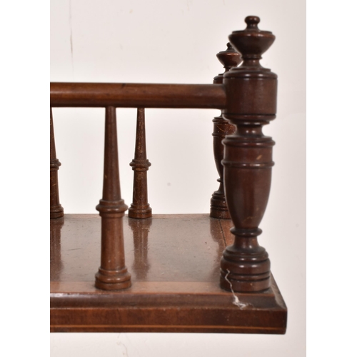 202 - An Edwardian mahogany inlaid revolving book reading table. The table having a circular inlaid top wi... 