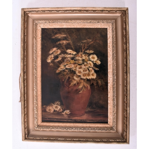 219 - An early 20th century still life of daisies oil on canvas painting. Depicting a terracotta vase with... 