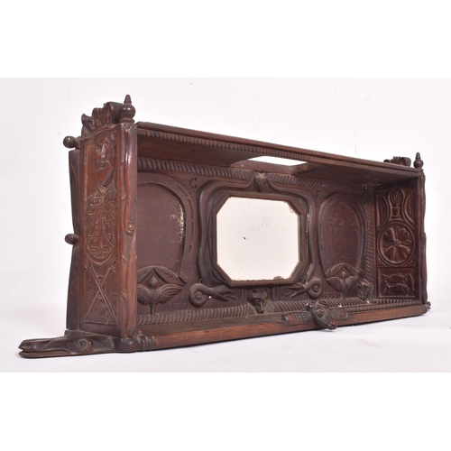 235 - An Edwardian early 20th century 1903 carved ebonised wood hanging cupboard shlef with mirror. The sh... 