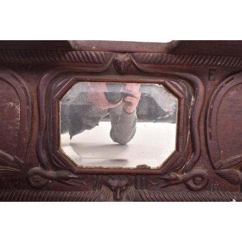 235 - An Edwardian early 20th century 1903 carved ebonised wood hanging cupboard shlef with mirror. The sh... 