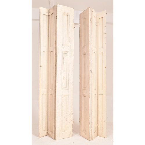 254 - A matching pair of 19th century George III bifold white painted window shutters. Each of slender for... 