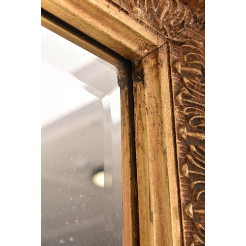 255 - A large Baroque inspired 19th century gilt wood ornate overmantel wall hanging mirror. The mirror ha... 