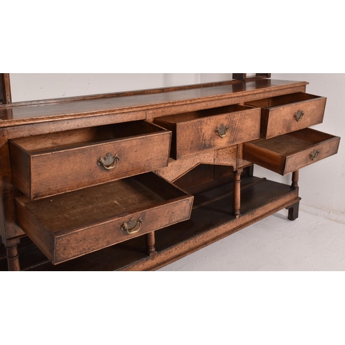 273 - A matched George III early 19th century oak Welsh dresser. The sideboard dresser's wider top with fl... 