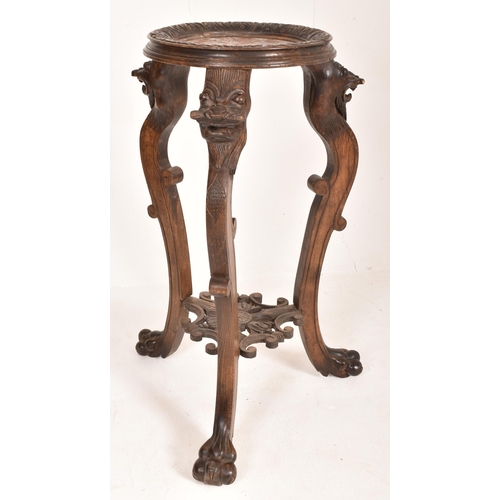 276 - A tall Chinese 19th century hardwood and marble top jardiniere / torchere plant stand. The torchere ... 