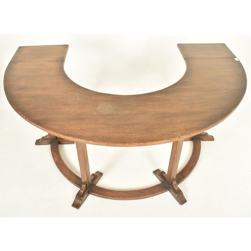 290 - A 20th century George III revival Ipswich solid oak half-moon desk. The desk having drop leaf ends w... 