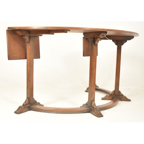 290 - A 20th century George III revival Ipswich solid oak half-moon desk. The desk having drop leaf ends w... 