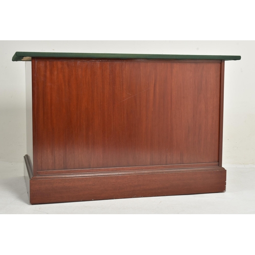 292 - A near pair of contemporary bespoke made mahogany office furnishings comprises an eight-drawer chest... 