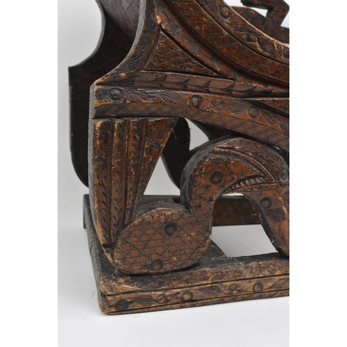 300 - An early 20th century African tribal wooden carved fruitwood stool chair. The chair with pierced bac... 